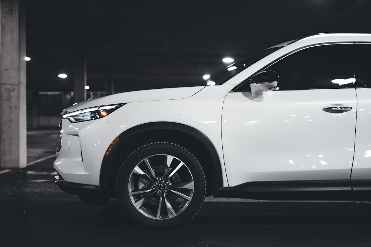 A stylish white SUV parked in an urban garage showcasing modern luxury design elements.